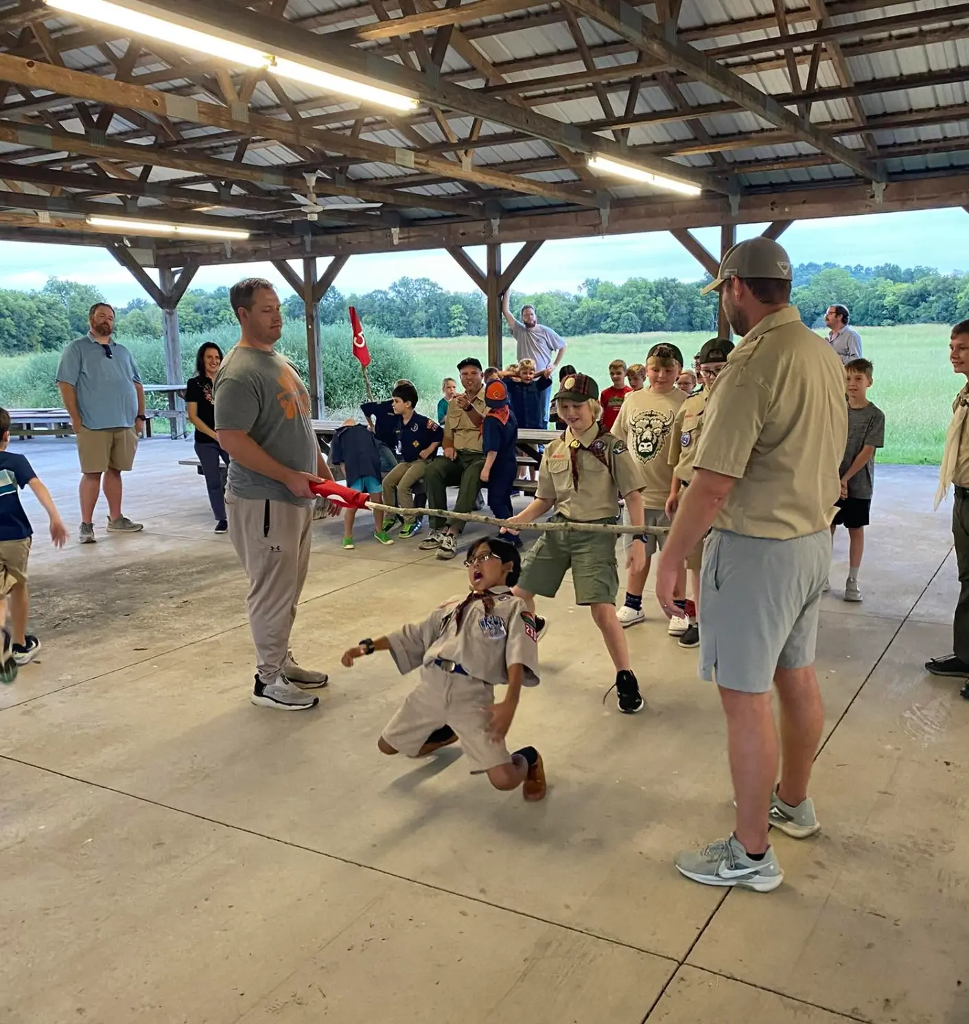 Scouts playing games at a pack meeting pavilion